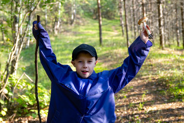 A boy found mushroom in the forest