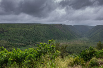 Kohala, Hawaii, USA. - January 15, 2020: Green Pololu valley from start to end under dark rainy cloudscape. 
