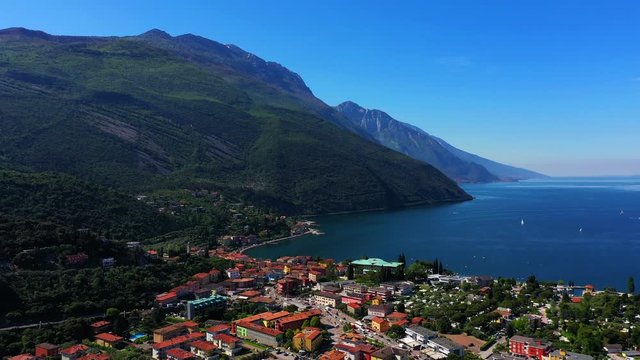 Panoramic view of the alps Lake Garda and the city of Riva del Garda, Italy. Aerial view. Perfect blue sky.	