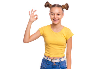 Portrait of teen girl making Ok Gesture, isolated on white background. Beautiful caucasian young teenager smiling and giving OK sign. Happy cute child showing okay.