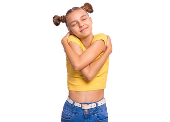 Self love and self care. Portrait of teen girl Hugging oneself, isolated on white background. Cute caucasian young teenager smiling with eyes closed. Happy funny child.
