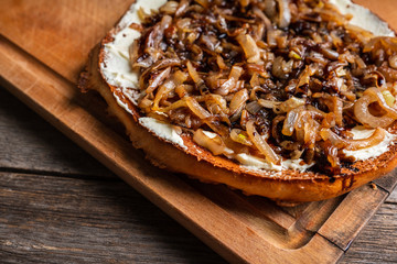 Homemade pizza with goat cheese, caramelized onion and balsamic vinegar. Selective focus. Shallow...