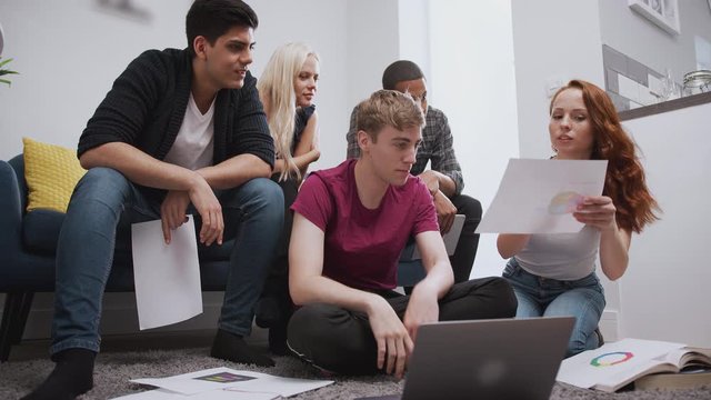 Group Of College Students In Shared House Bedroom Studying Together