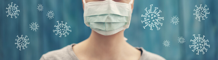 young woman in medical face protection mask indoors on blue background - obrazy, fototapety, plakaty