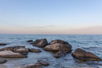 Fototapeta na wymiar View of blue sea waves at rocky beach. Horizon line. Caspian Sea, sandstone coast. ustyurt. Selective focus, long shutter speed