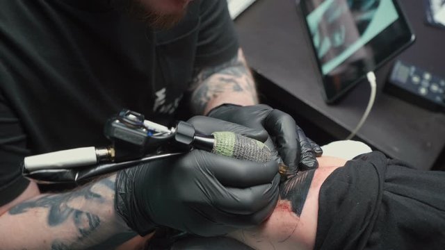 Video of professional getting tattoo of snake in salon