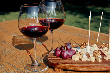 Glasses Of Fine Red Wine With Grape and cheese