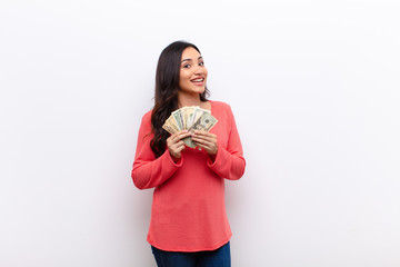 young latin pretty woman  against flat wall money concept