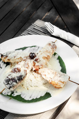 fish skewers with creamy coconut sauce and rice in vietnam