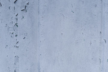 gray-blue wall with cracked paint. texture.