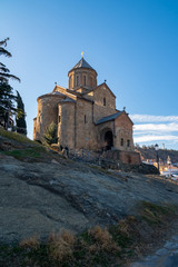 Fototapeta na wymiar View Metekhi Church in the morning above the Kura river in Tbilisi