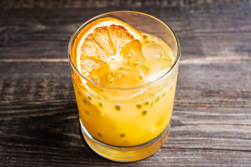 Old fahioned passion fruit cocktail on the rustic background. Selective focus. Shallow depth of field.
