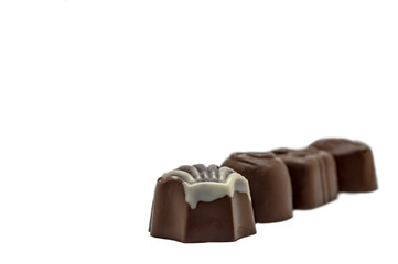 candy of milk and white chocolate on a white background close-up