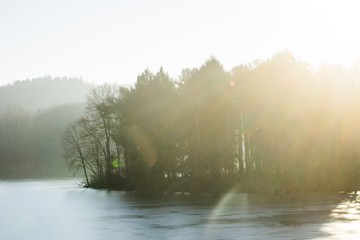 sunbeams over frozen river