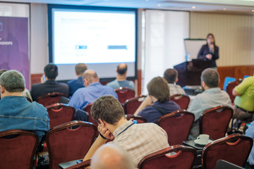 Fototapeta premium Business conference attendees sit and listen