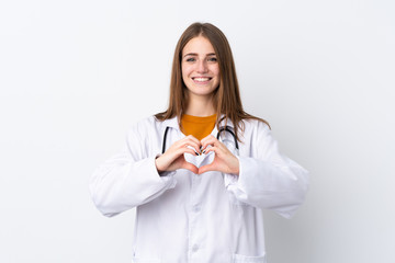 Young woman over isolated background wearing a doctor gown making a heart with hands