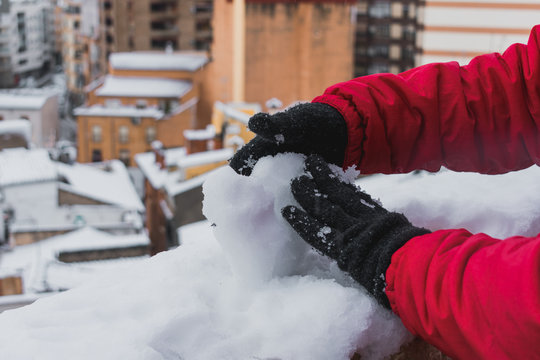 Close-up view of a young man playing with the snow