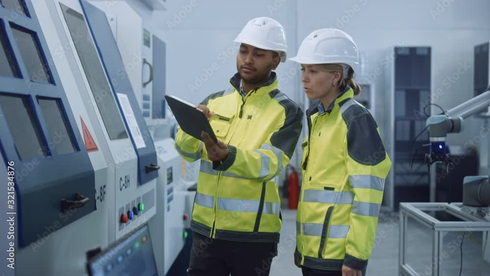 Aufkleber Chief Engineer and Project Manager Wearing Safety Vests and Hard Hats, Use Digital Tablet Computer in Modern Factory, Talking, Optimizing CNC Machinery, Programming Machine for Increasing Efficiency