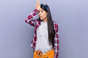 young latin woman raising palm to forehead thinking oops, after making a stupid mistake or...