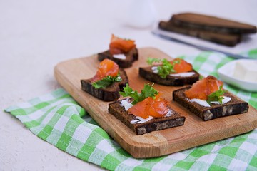 Appetizer, open sandwiches on rye bread with slightly salted salmon and butter. Swedish cuisine. Selective focus.