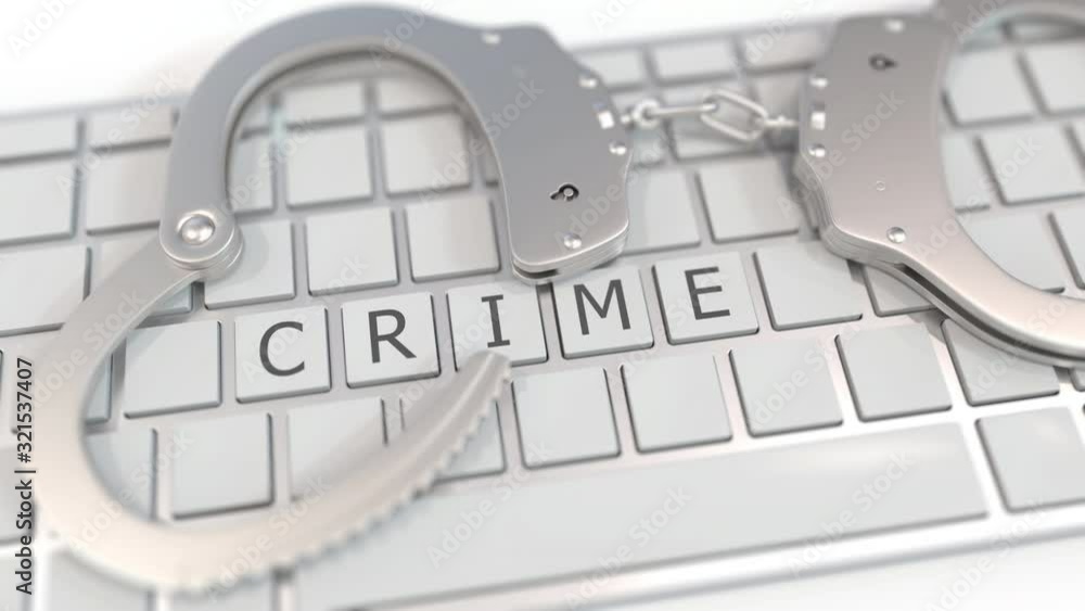 Aufkleber handcuffs on keyboard with crime word. computer crime related conceptual 3d animation