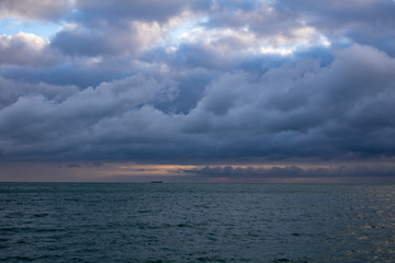 blue dark cumulus stormy clouds above the sea