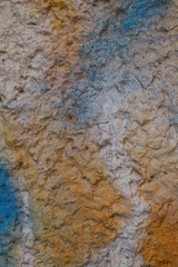 Blurred abstract background. Orange with blue stripe tuberous cement surface. Beautiful abstract background. Texture painted stone wall. Textured gradient background. Vertical, close-up.