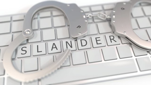 Handcuffs on keyboard with SLANDER word on keys. Crime related conceptual 3D animation