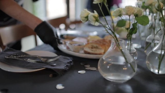 The waiter sets the table in a restaurant