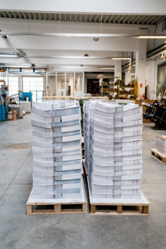 Stacks Of Papers On Pallets In A Printing Shop