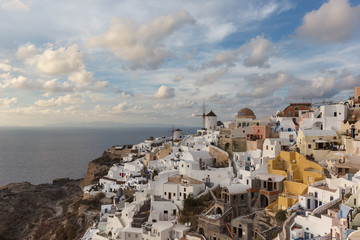 Fototapeta na wymiar he city on Santorini in Greece is Oia, a place where the most beautiful sunsets are set against the backdrop of the Caldera, old houses and mills. The most popular sunset viewing point