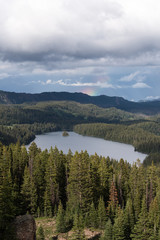 View Point on Grand Mesa National Forest Colorado has over 300 lakes. Partial Rainbow above Island Lake, which is one of the more popular destinations on the Grand Mesa.