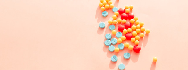 multicolored pharmaceutical pills thermometer a pink background. Copy space. the concept of health. concept  of life. assorted medicines. bright pills. coronavirus