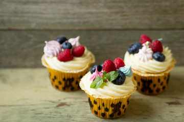 Delicious  cupcakes  with fresh berries .Dessert for lovers .