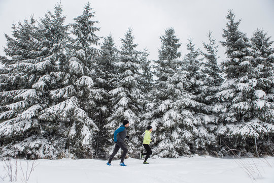 Couple doing cross country run in winter
