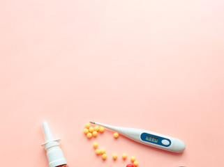 multicolored pharmaceutical pills thermometer, bottle, phonendoscope on a pink background. Copy space. the concept of health. concept  of life. assorted medicines. bright pills. coronavirus