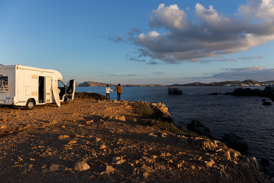 Back view of couple enjoying view hand in hand, Es Mercadal, Menorca, Spain