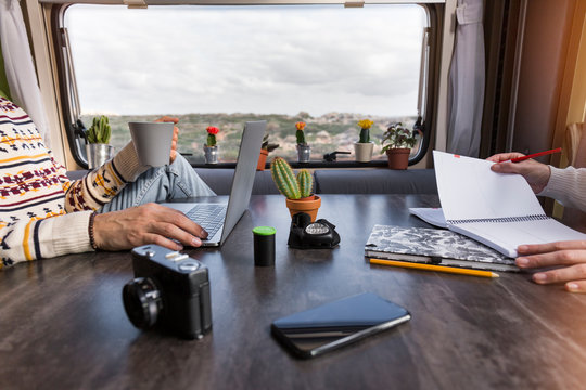 Crop view of couple working in camper, Es Mercadal, Menorca, Spain