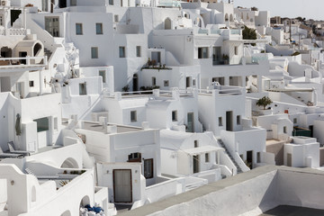 small traditional white houses with a view of the Caldera, the symbol of the island of Santorini in Greece, a view of the island's capital Fira and villages nearby