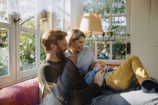 Happy Family Having Fun In Sunroom At Home