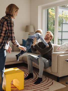 Happy Family In Living Room At Home