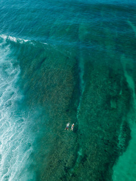 Indonesia, Sumbawa, Aerial view of surfers on sea