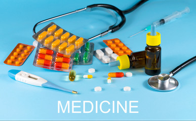 Set of pills on a blue background. Human health. Medicine. Blue background, place for text. Copy...