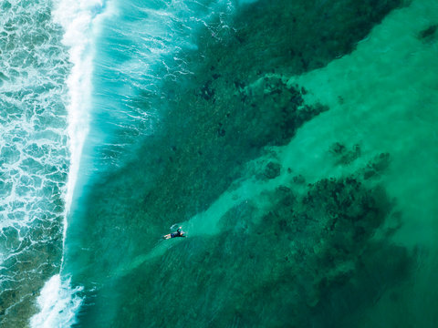 Indonesia, Sumbawa, Aerial view of surfer on sea