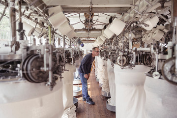 Man working at a machine in a textile factory