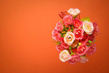 Greeting card bouquet of small roses, background orange. St. Valentine's Day