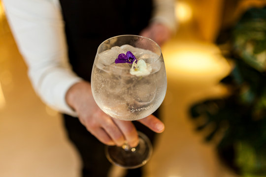 Waiter serving a gin and tonic