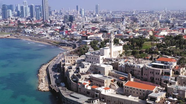 Pull back reveal shot from Jaffa St.Peter church tower to a full view of Tel Aviv coastline with The old city Marina of Jaffa.