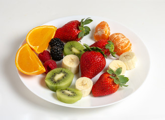 Assorted fruit plate on white background