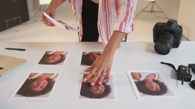 Female Photographer Editing Images From Photo Shoot In Studio 